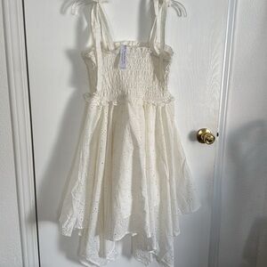 Here’s a polished version of your VENUS Cream Smocked Tie Front Sundress NWT